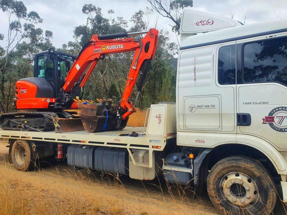 Towing An Orange Excavator