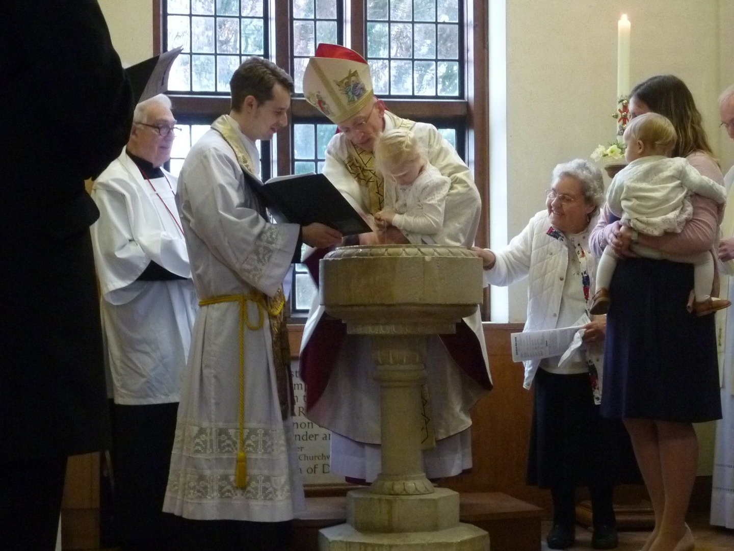 The Bishop of Chichester baptising a child