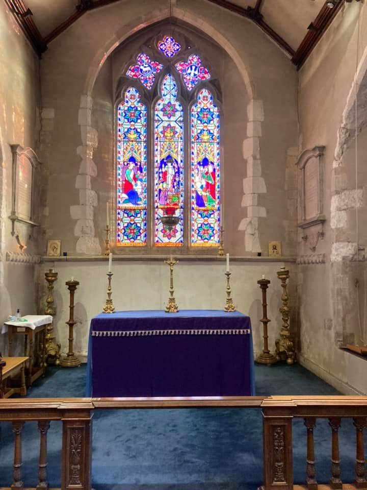 View of altar with stained glass window behind (inside St James the Less)