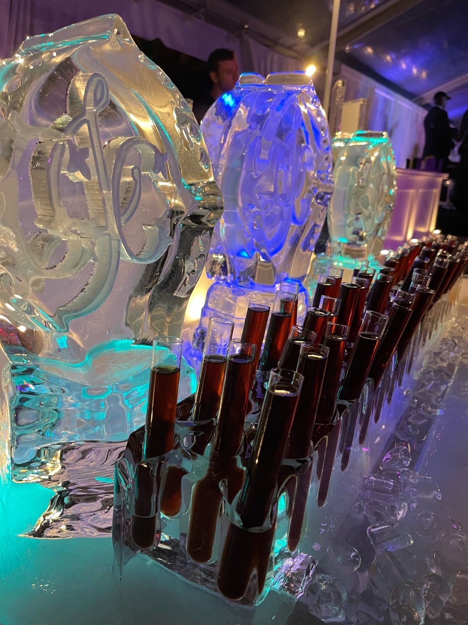 A Row of Shot Glasses are lined up in front of Ice Sculptures