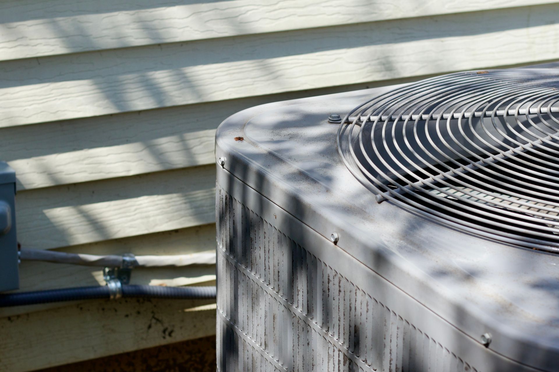 a close up of an air conditioner on the side of a house