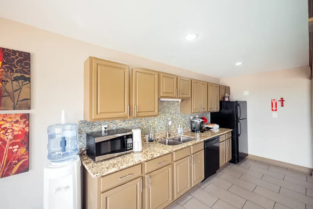 A kitchen with a refrigerator , microwave , and dishwasher.