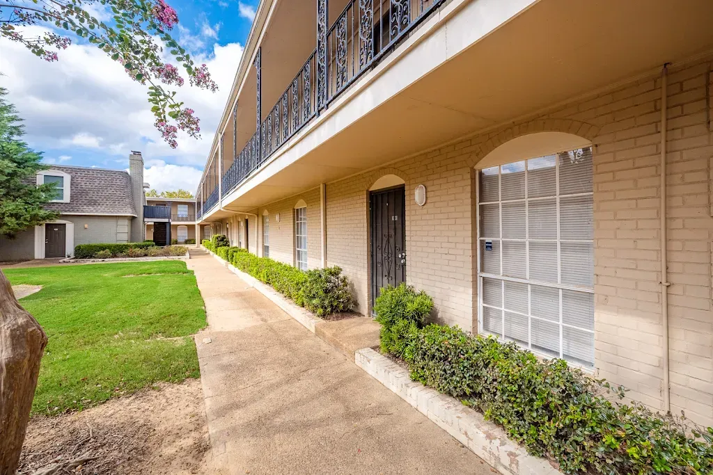 A building with a lot of windows and a walkway leading to it.