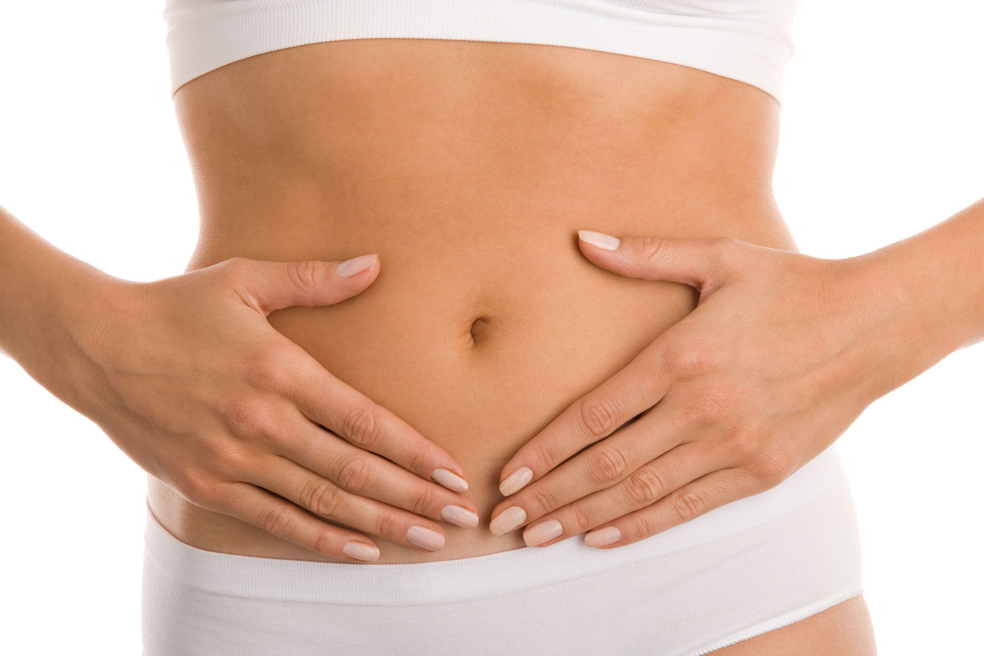 Woman in white underwear holding hands over abdomen.
