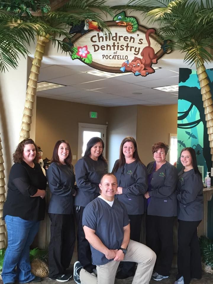 A dental team posing under a 