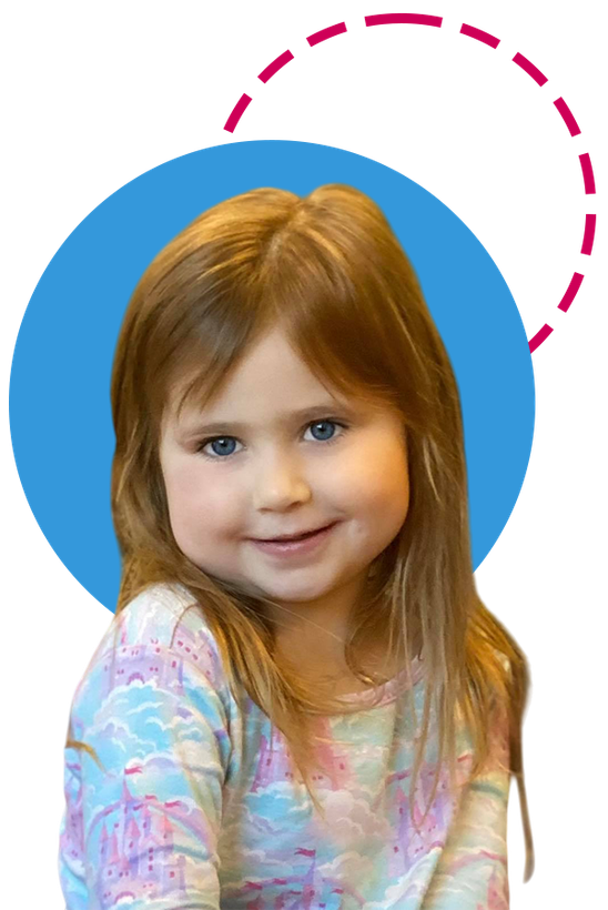 Smiling child with light brown hair, wearing a patterned top