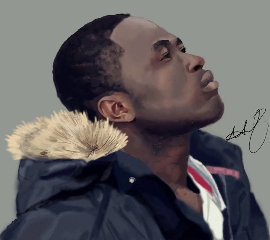 Man looking up, wearing a dark jacket with fur trim.