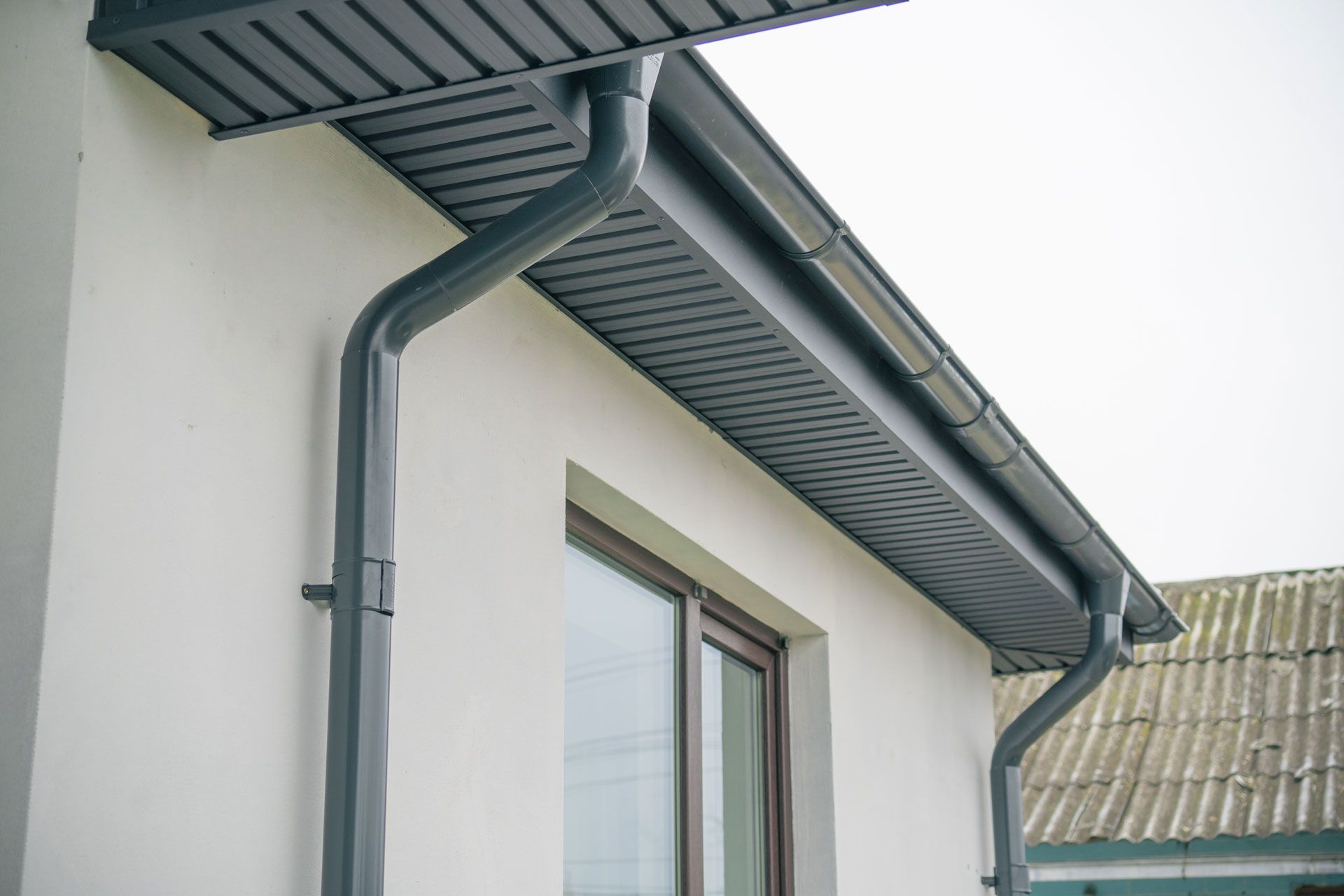 A house with a gutter on the side of it