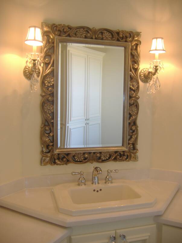 A bathroom with a sink and a mirror on the wall