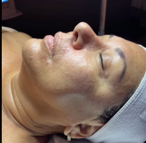 A woman is laying down with her eyes closed