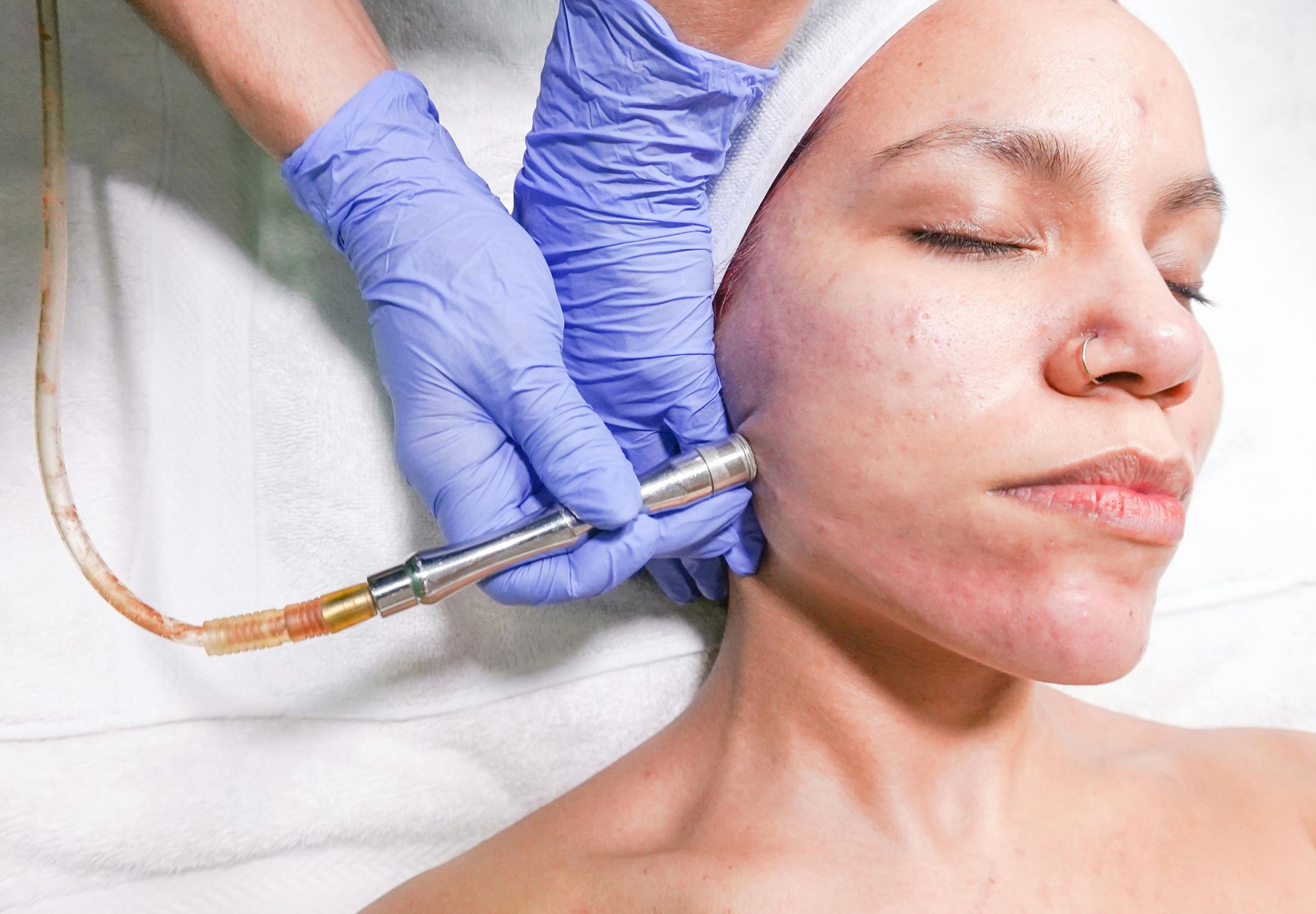 A woman is getting a facial treatment at a beauty salon.