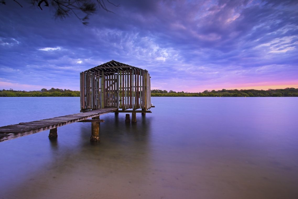 There Is A Dock In The Middle Of A Lake At Sunset — Homemakers Lifestyle In Maroochydore, QLD