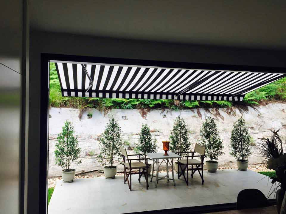 A Patio With A Table And Chairs Under An Awning — Homemakers Lifestyle In Nambour, QLD