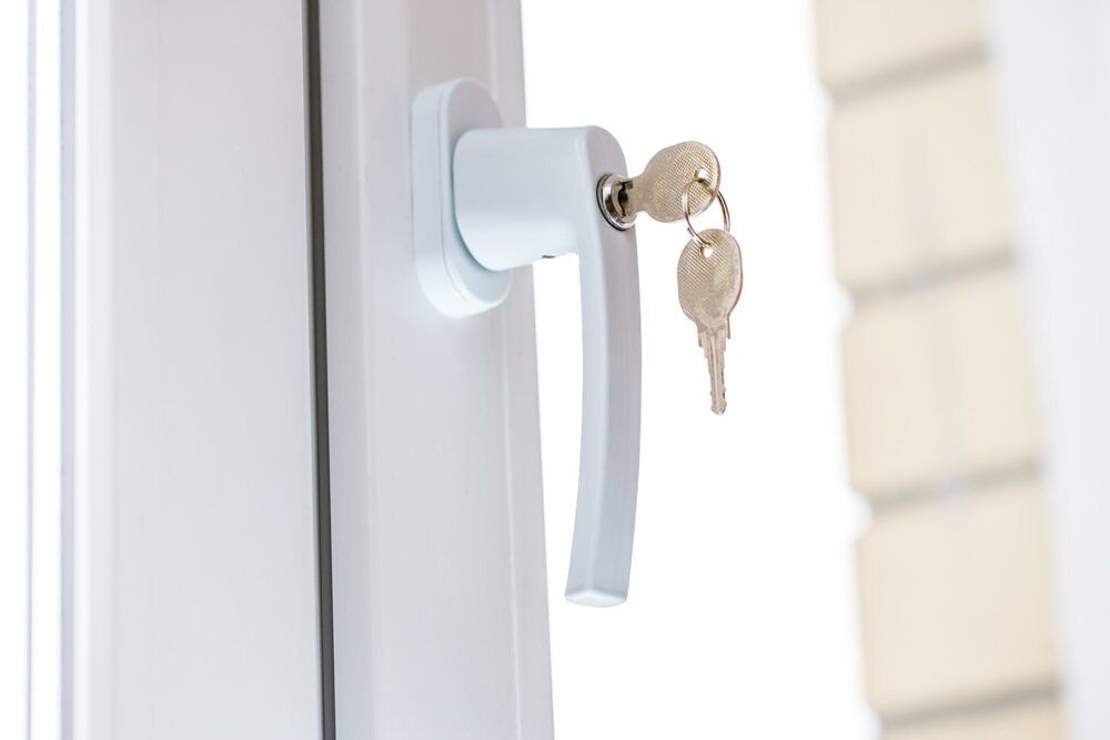 A White Plastic Window Handle With A Key In It — Homemakers Lifestyle In Noosa, QLD