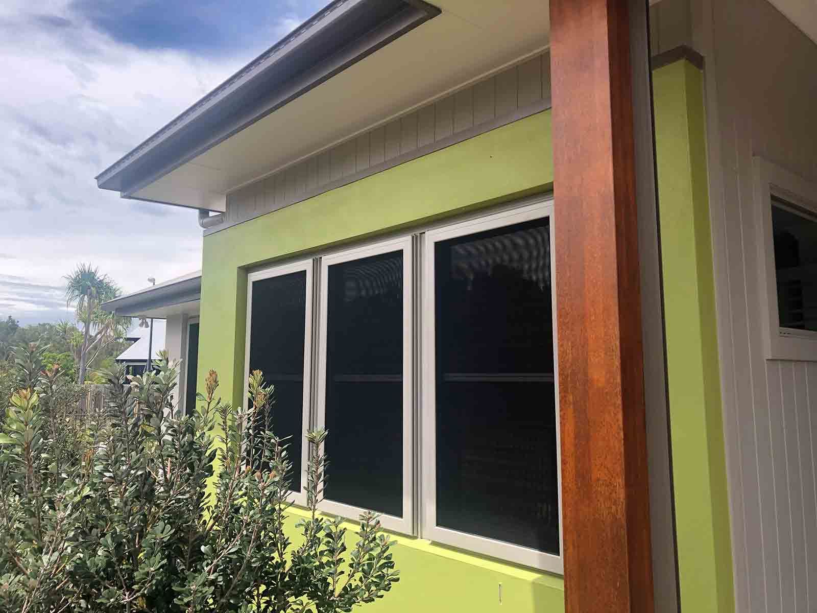A Green House With Two Windows And A Wooden Post — Homemakers Lifestyle In Nambour, QLD