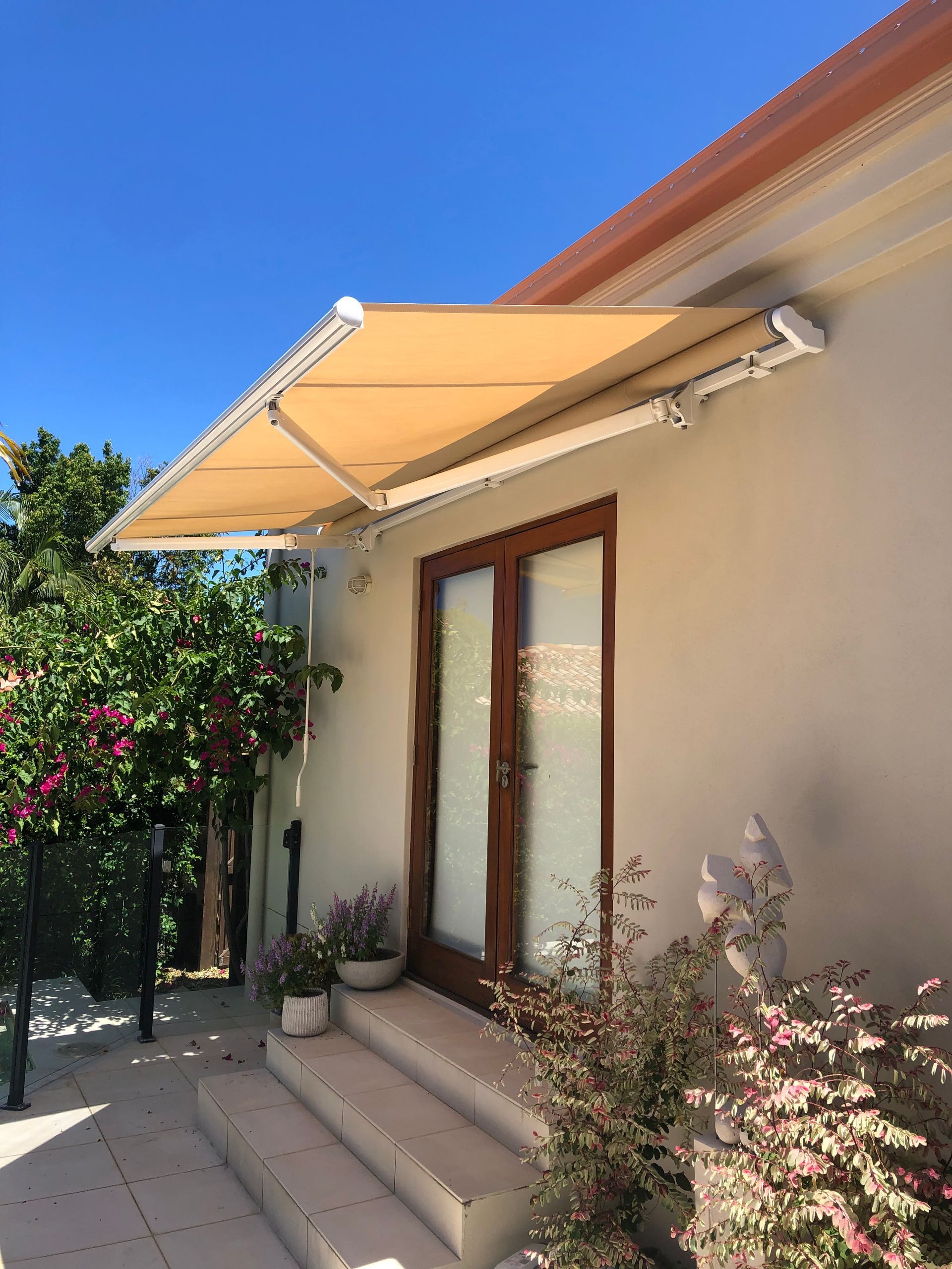 A House With A Yellow Awning Over The Door And Stairs — Homemakers Lifestyle In Maroochydore, QLD