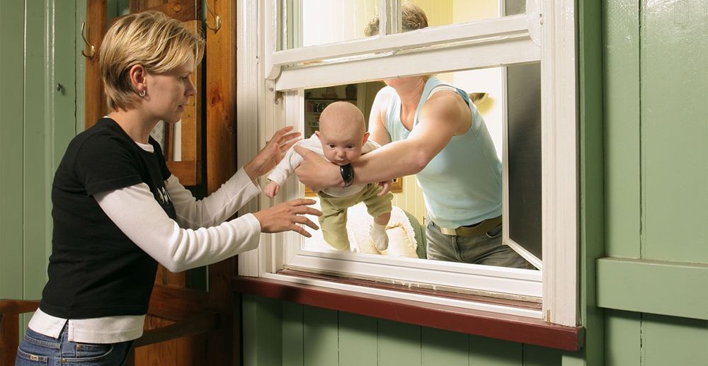 Man pass the baby in the Window to the Woman — Homemakers Lifestyle Maroochydore In Maroochydore QLD
