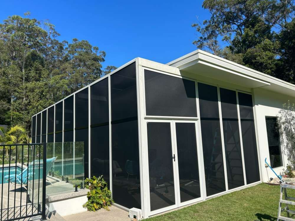 A House With A Screened In Area Next To A Pool — Homemakers Lifestyle In Maroochydore, QLD