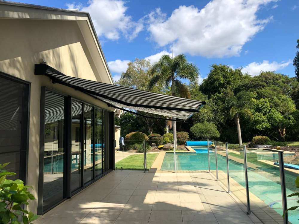 A House With A Swimming Pool And A Patio With A Canopy Over It — Homemakers Lifestyle In Maroochydore, QLD