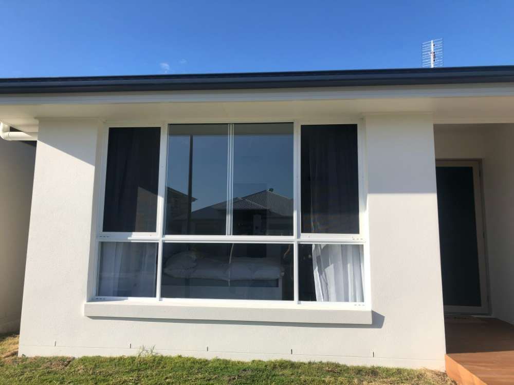 A White House With A Large Window And A Blue Sky In The Background — Homemakers Lifestyle In Maroochydore, QLD