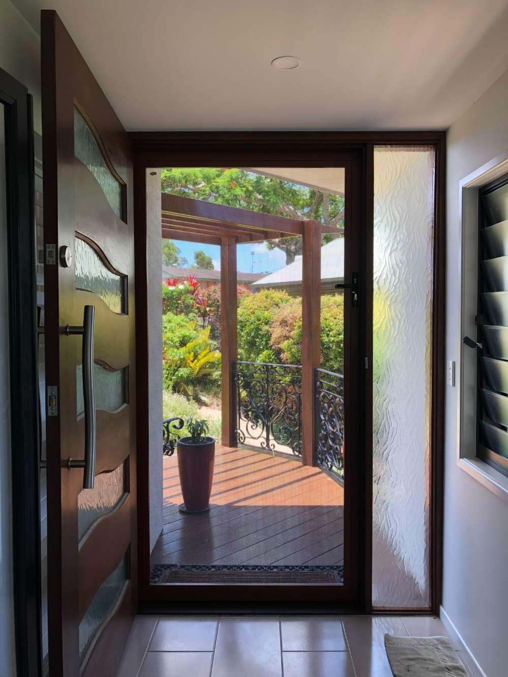 A Hallway With A Glass Door Leading To A Deck And A Potted Plant — Homemakers Lifestyle In Maroochydore, QLD