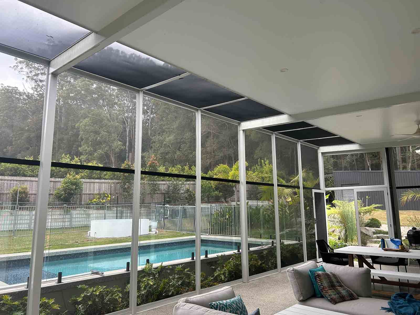 A Screened In Porch With A Swimming Pool In The Background — Homemakers Lifestyle In Maroochydore, QLD