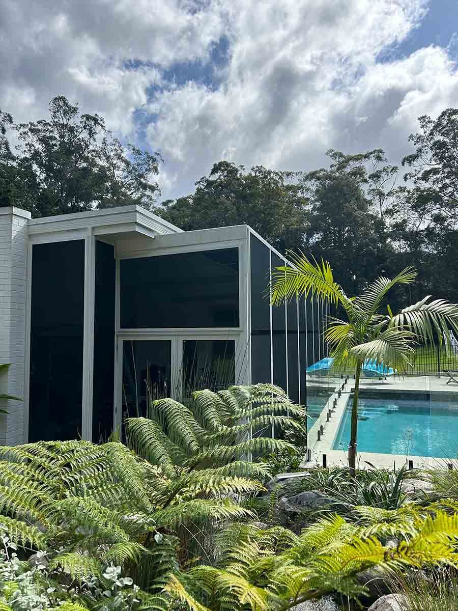 A House With A Swimming Pool And Ferns In Front Of It — Homemakers Lifestyle In Noosa, QLD