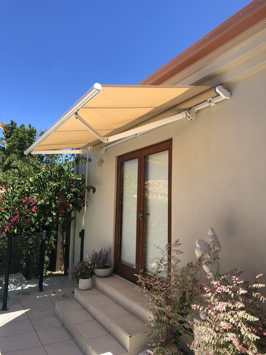 A White House With a Yellow Awning Over the Door — Homemakers Lifestyle In Maroochydore, QLD