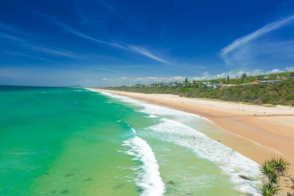 An Aerial View Of A Beach With Waves Coming In On A Sunny Day — Homemakers Lifestyle In Nambour, QLD