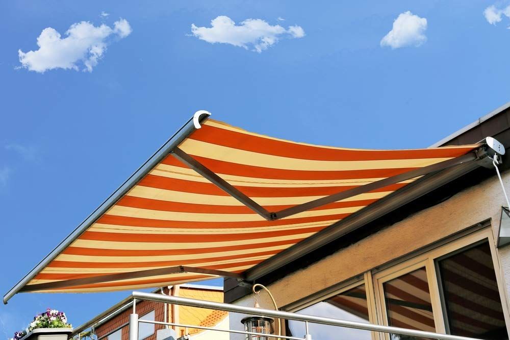 An Orange And Yellow Striped Awning Is Hanging From The Roof Of A Building — Homemakers Lifestyle In Caloundra, QLD