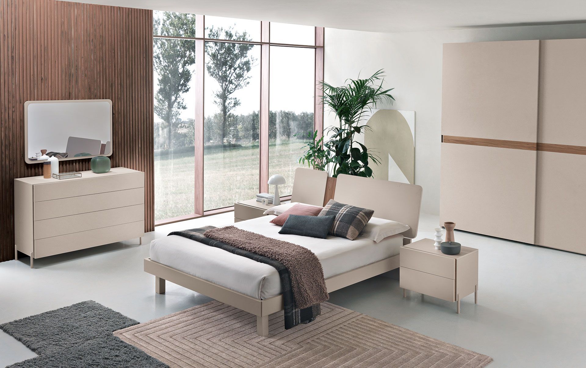 Una camera da letto con un letto, una cassettiera e un comodino