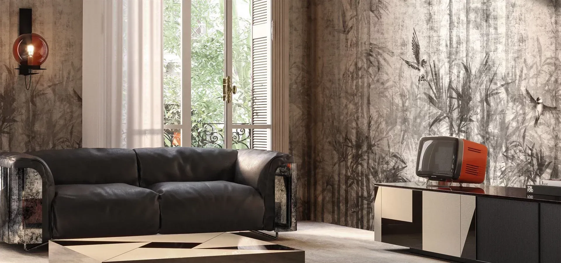 Un soggiorno con un divano nero, un tavolino da caffè e la televisione.