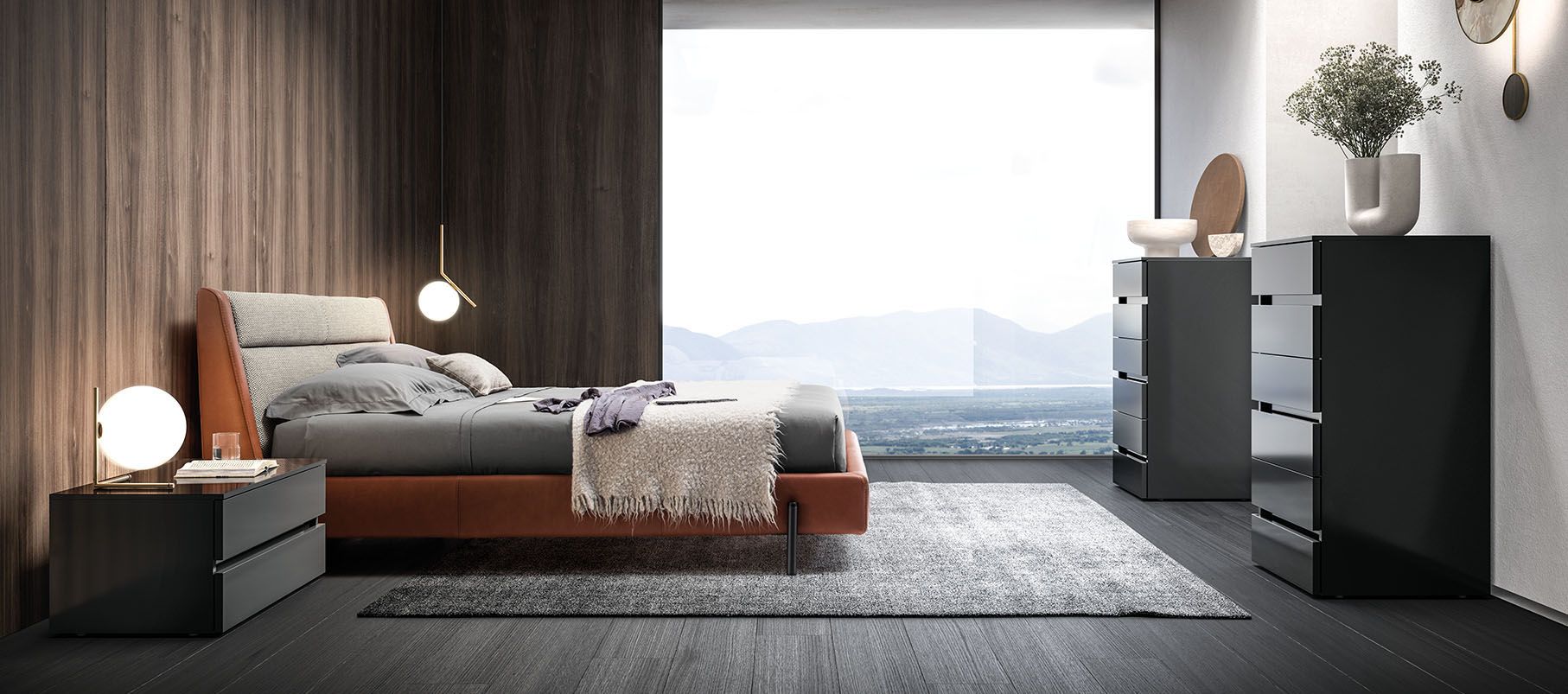 Una camera da letto con un letto, una cassettiera, un comodino e un tappeto.