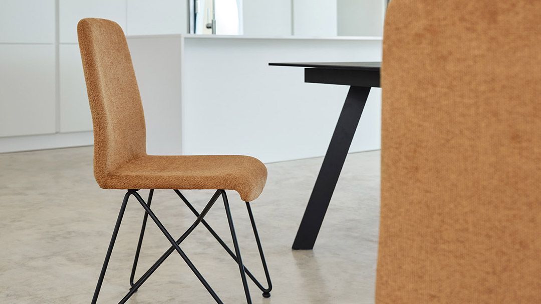 Una sedia è appoggiata accanto a un tavolo in cucina.