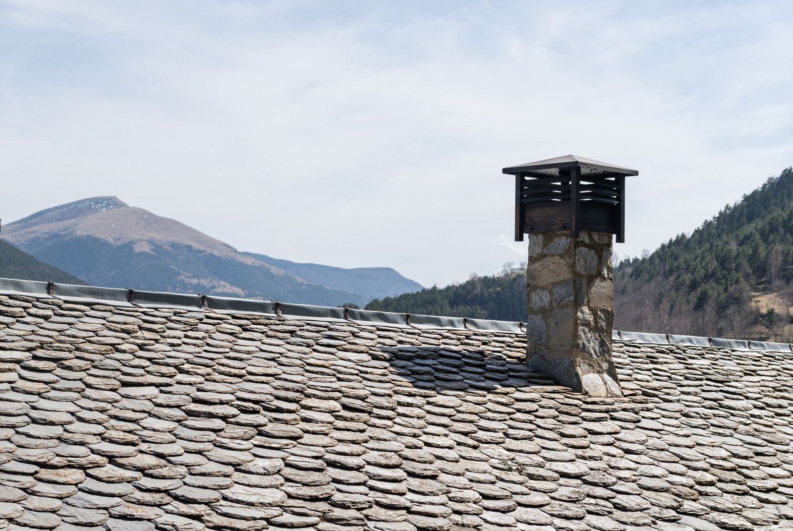 A wooden fence is sitting on top of a lush green field.