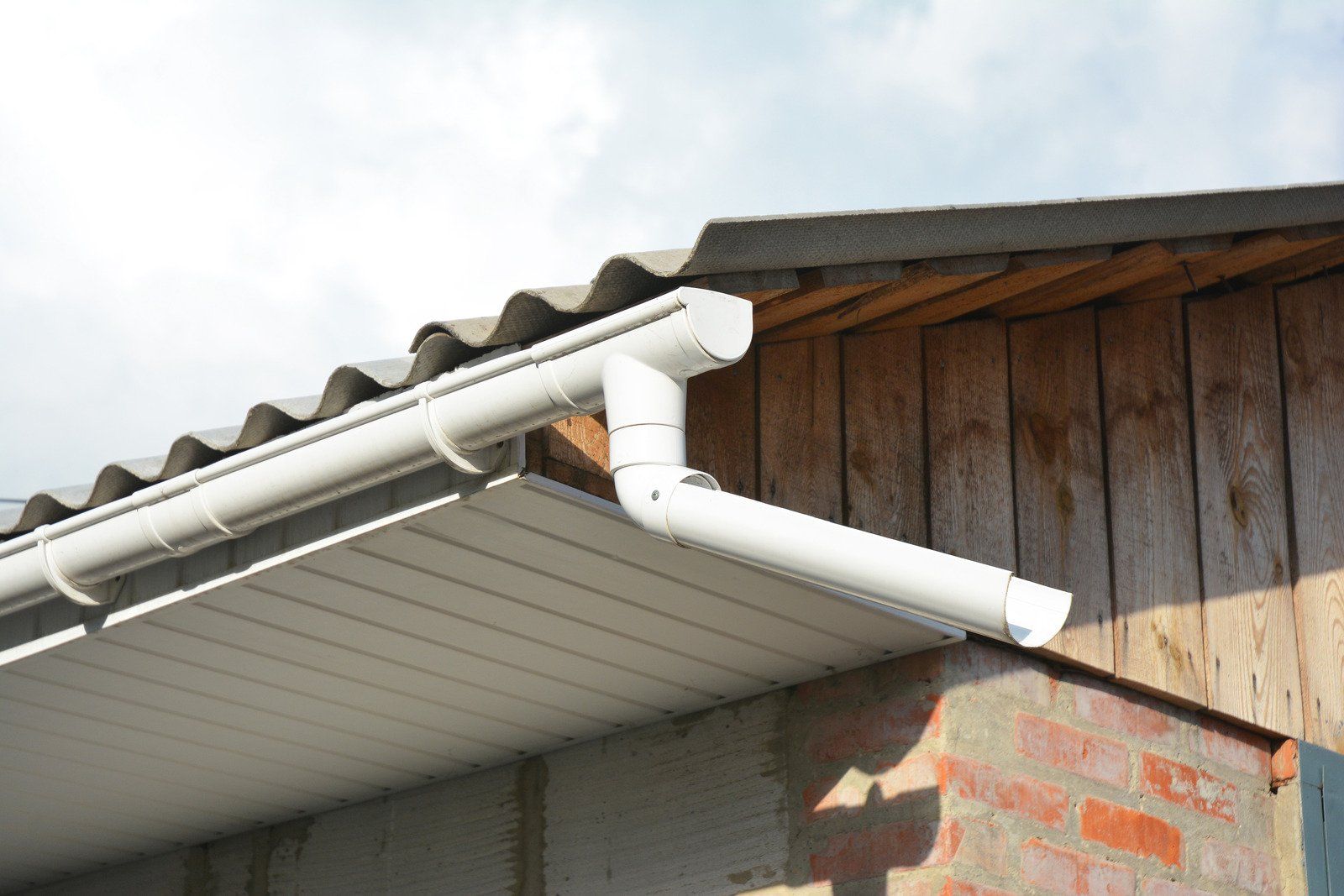 A wooden fence is sitting on top of a lush green field.