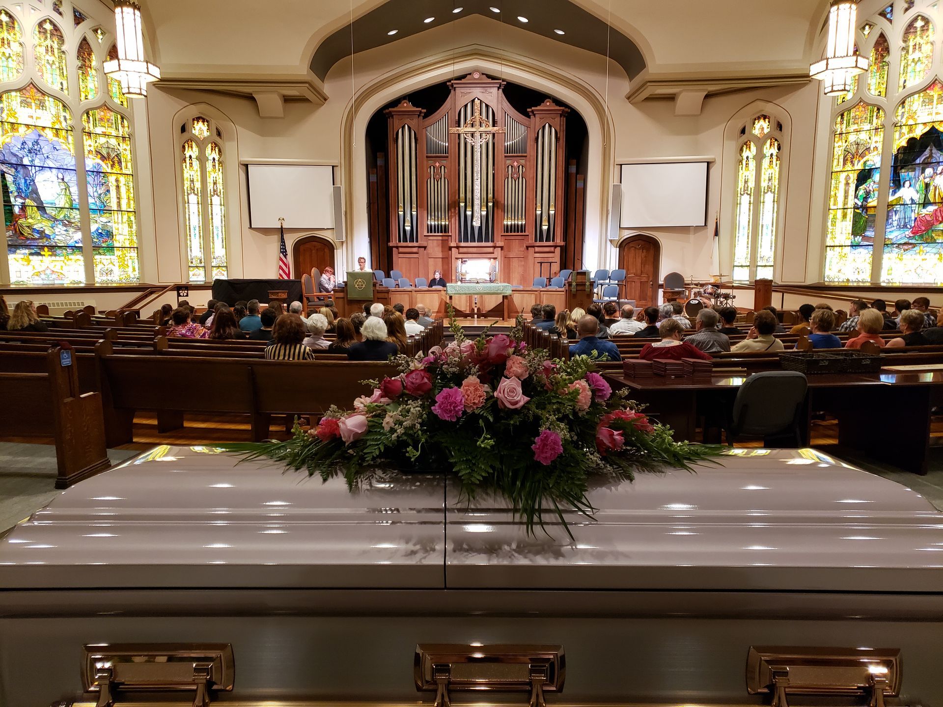 Casket with flowers in church sanctuary