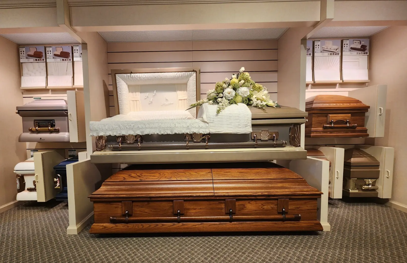 A row of coffins are sitting on top of each other in a room.