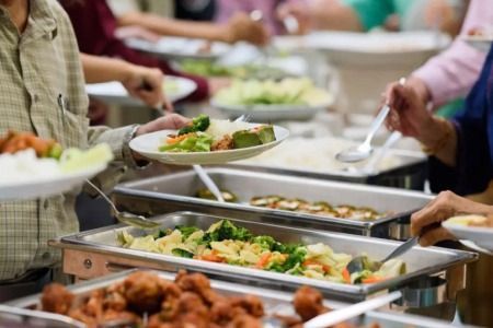 A photo of multiple catering dishes with food