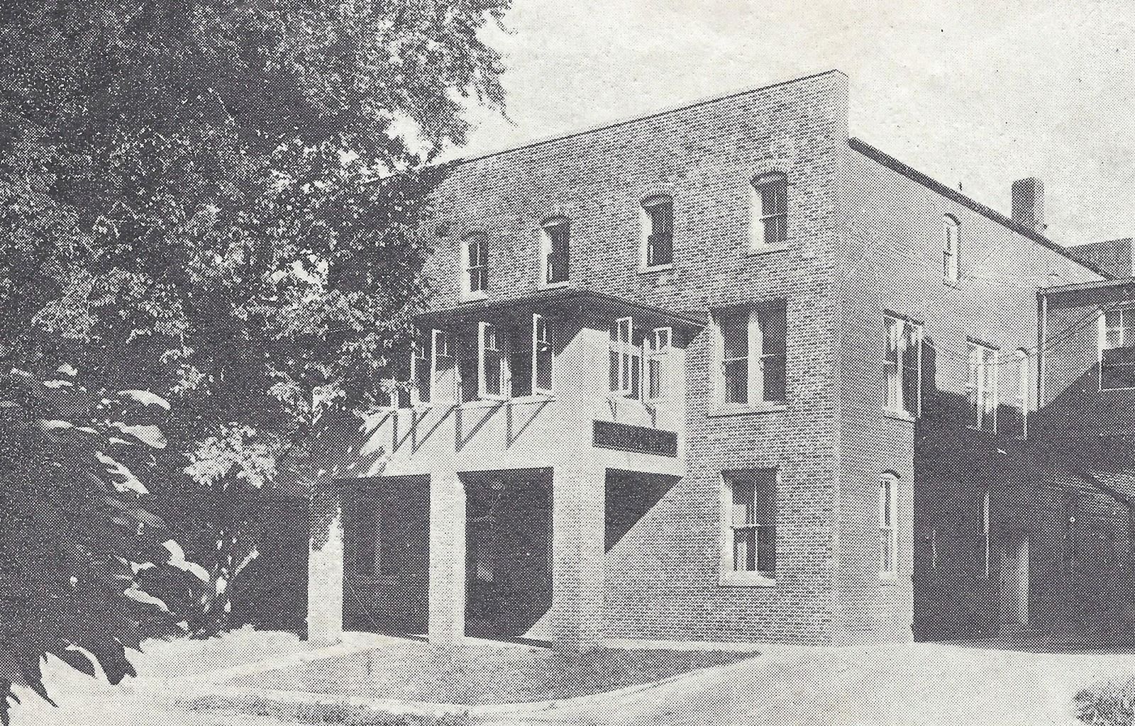 A black and white photo of a large brick building