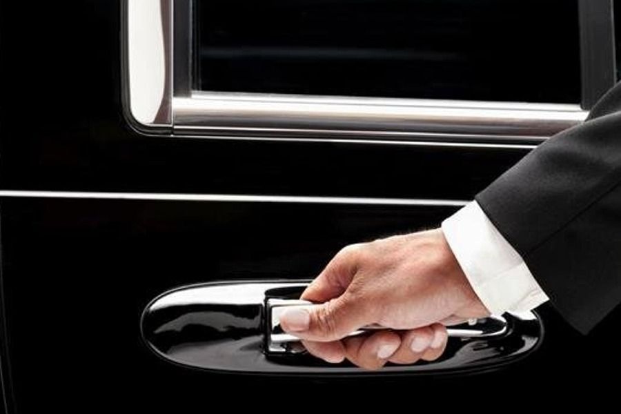 A hand holding a car door handle