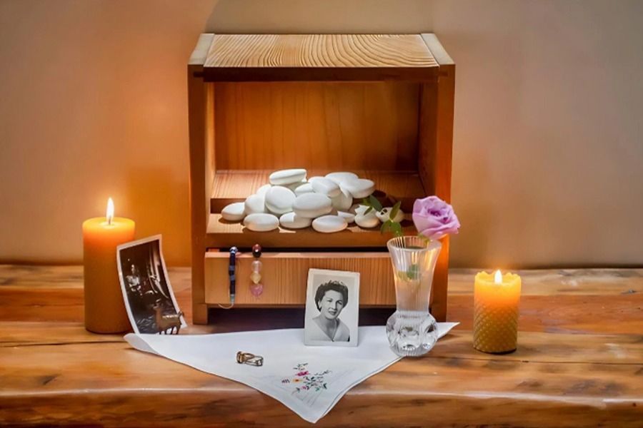 White stones in small cabinet with memorabilia