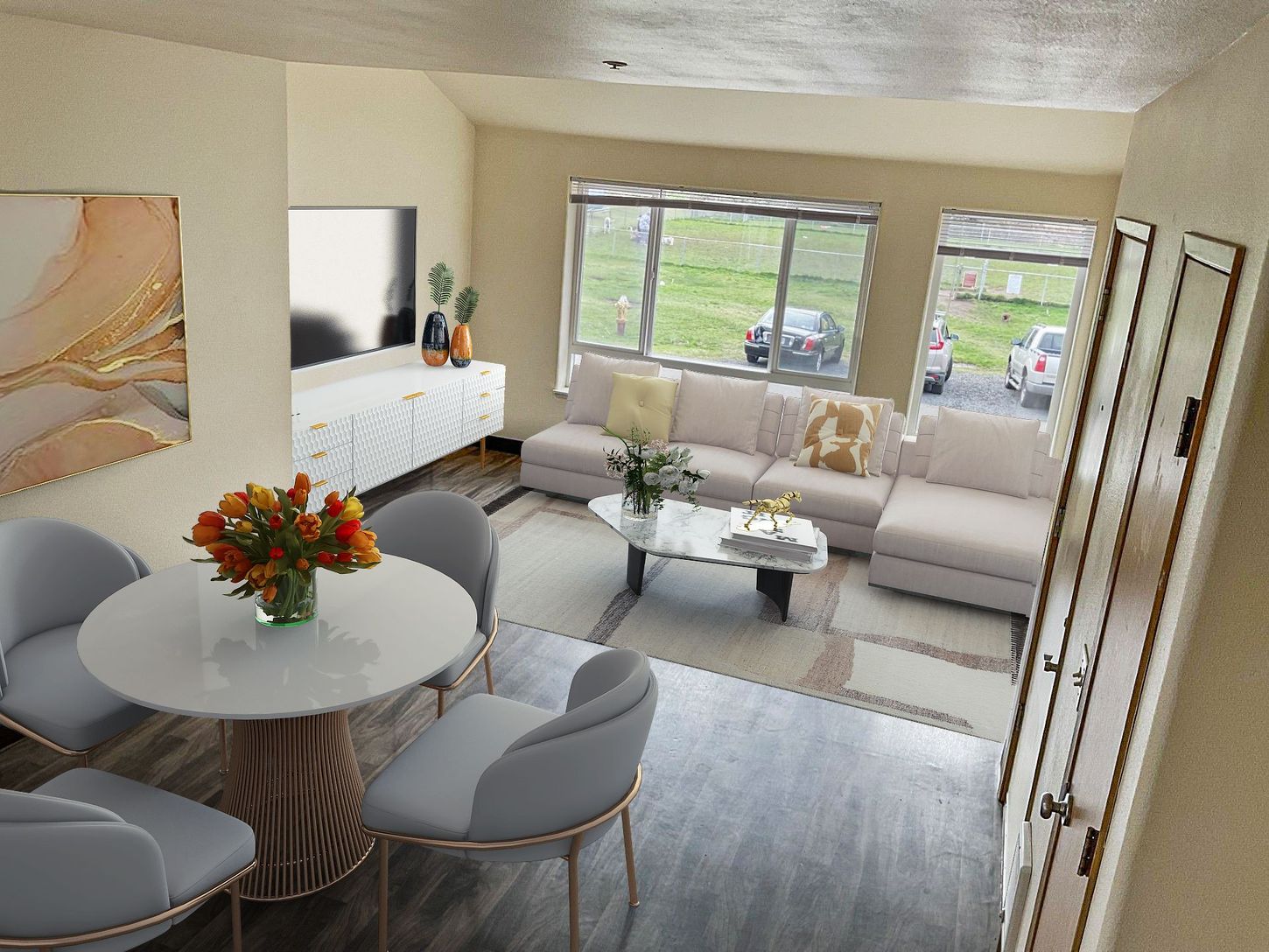 A living room with a couch , table and chairs