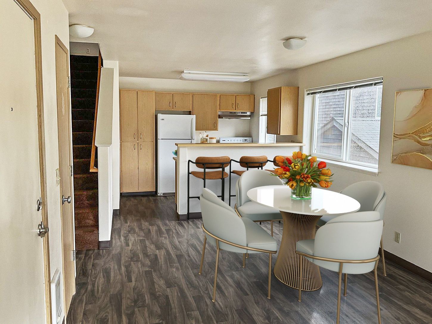 A kitchen with a table and chairs and a refrigerator
