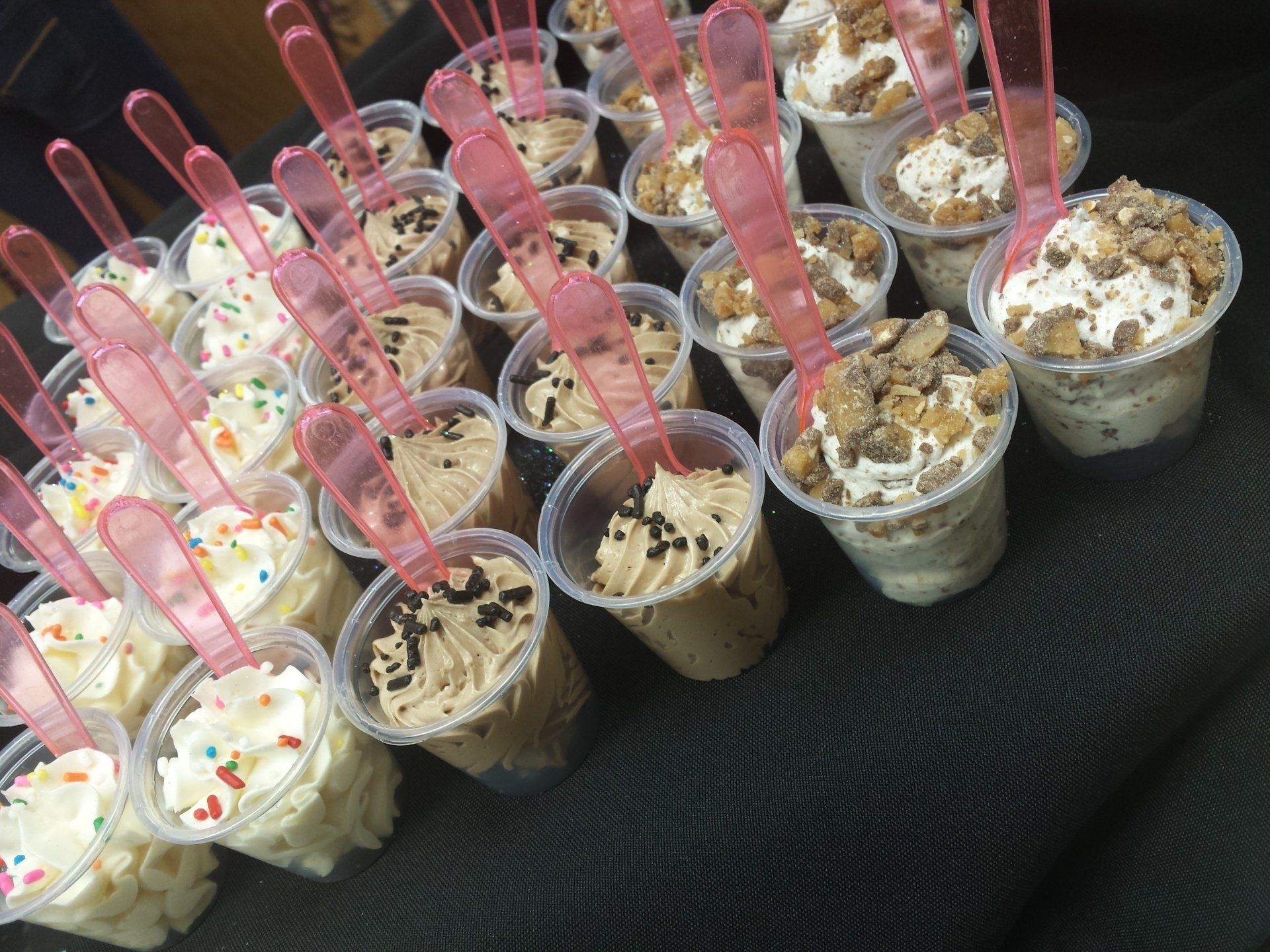 A tray of dessert cups in assorted flavors