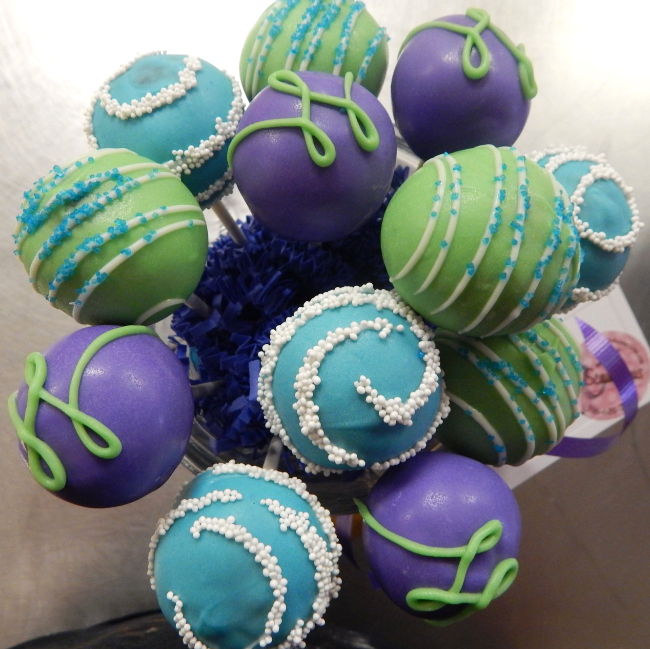 Bouquet of cake pops in green, purple, and blue