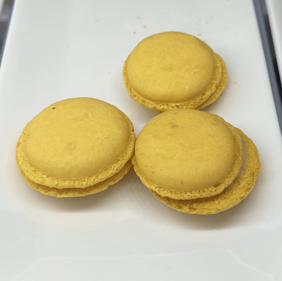 Three yellow macarons
