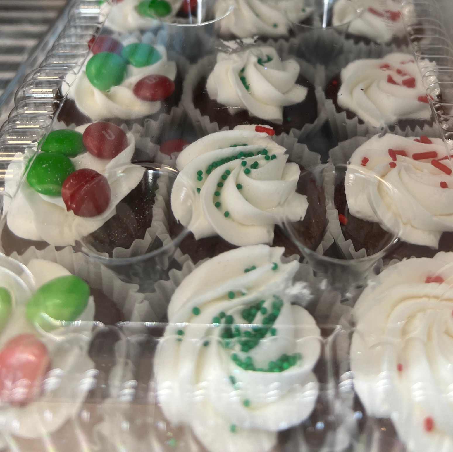 Mini Cupcakes with white icing and holiday decorations