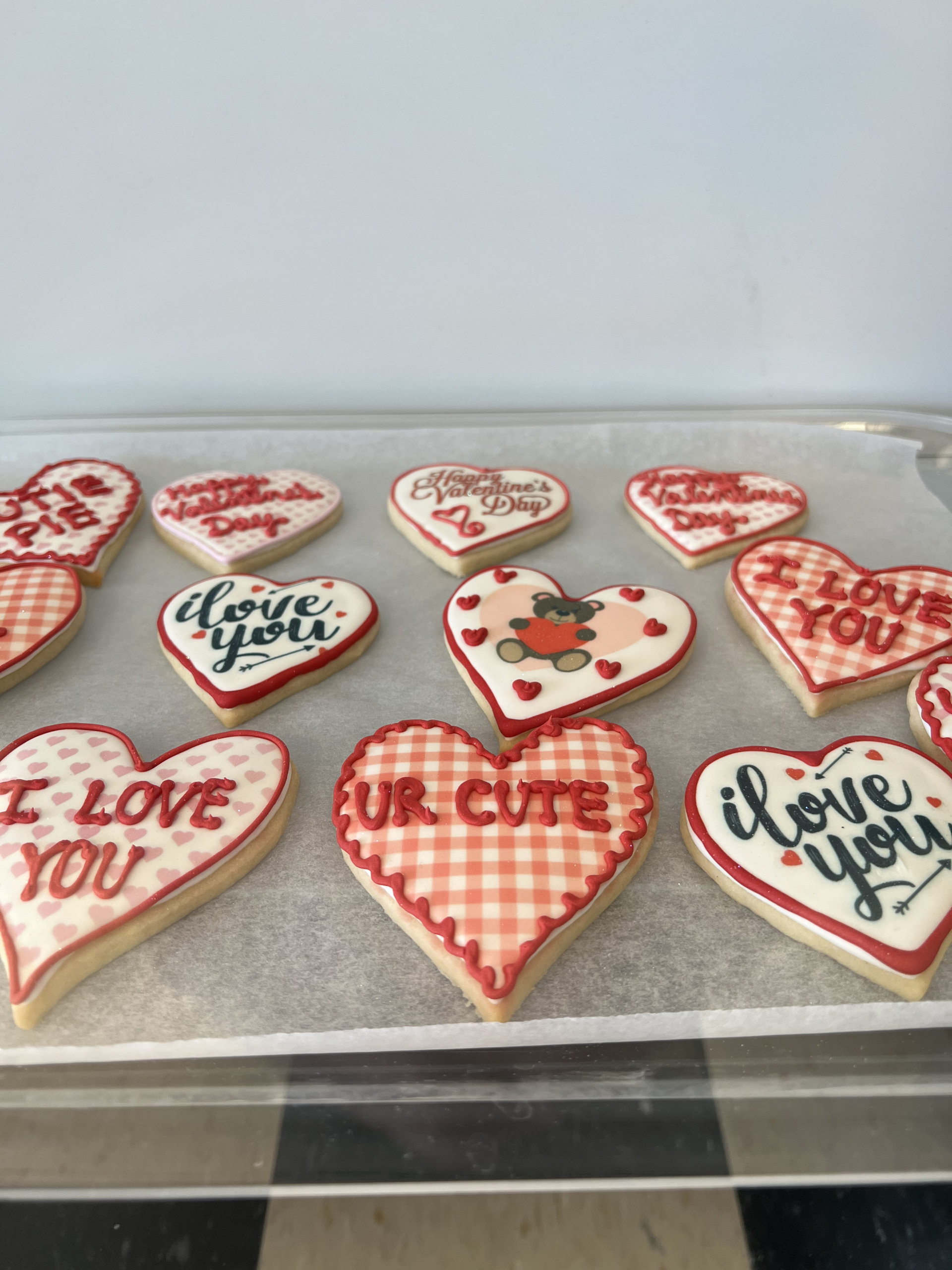 A tray of sugar cookies shaped and iced like valentine hearts