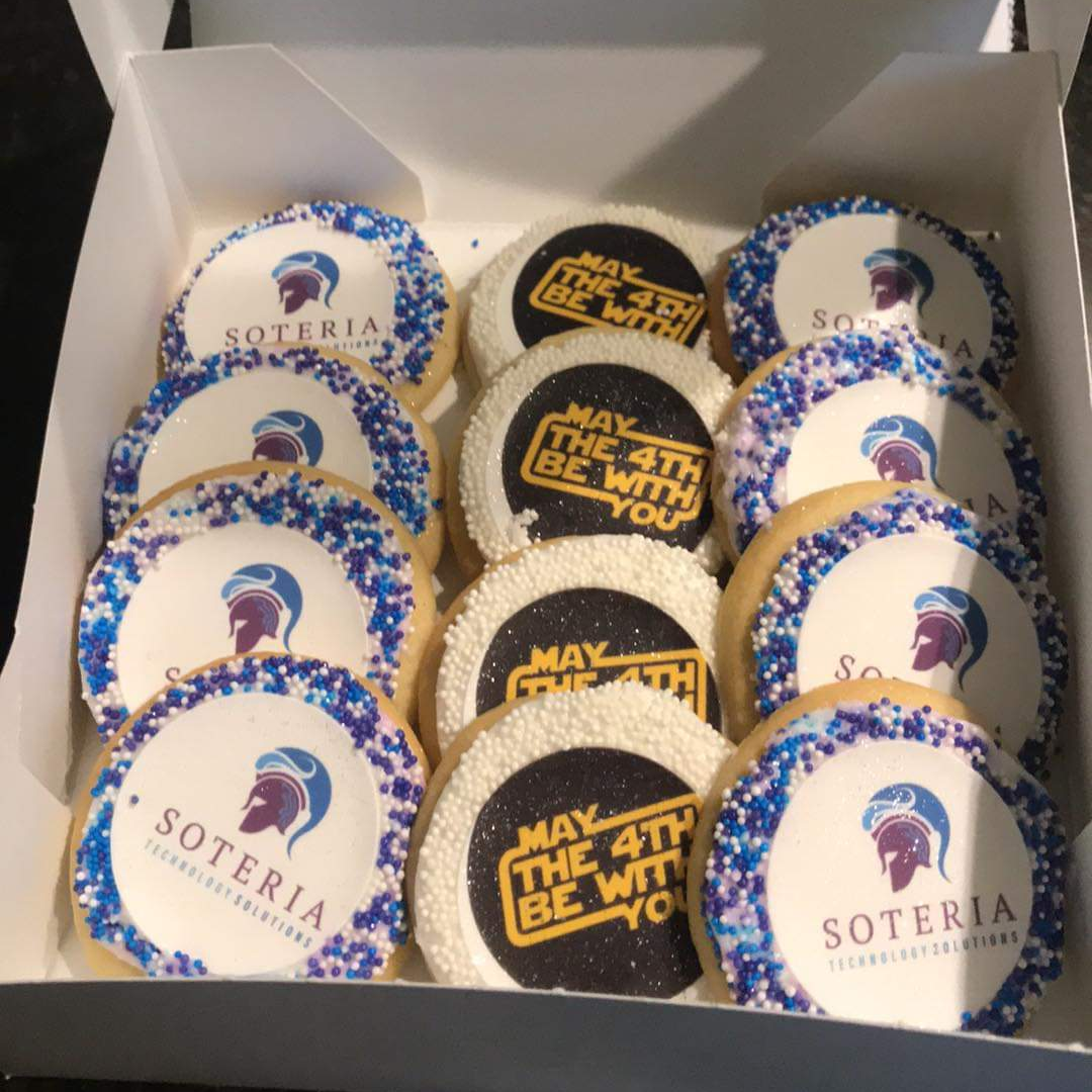 Sugar cookies with printed logos on the icing, ringed with sprinkles